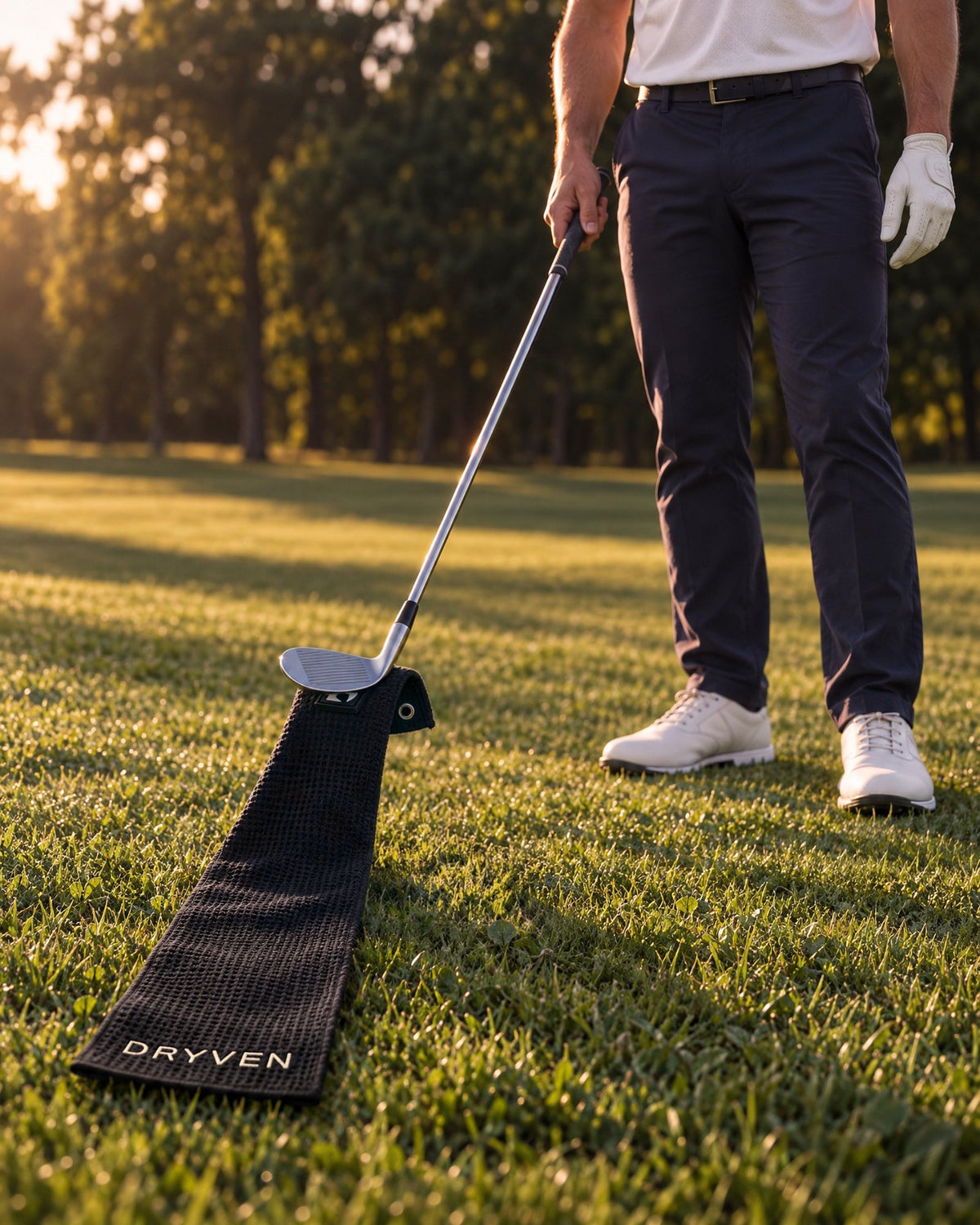 Wedge lifting the towel off the grass by its magnetic clip