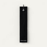 Black Dryven golf towel folded in thirds with screw-lock carabiner, magnetic logo badge and cream wordmark.